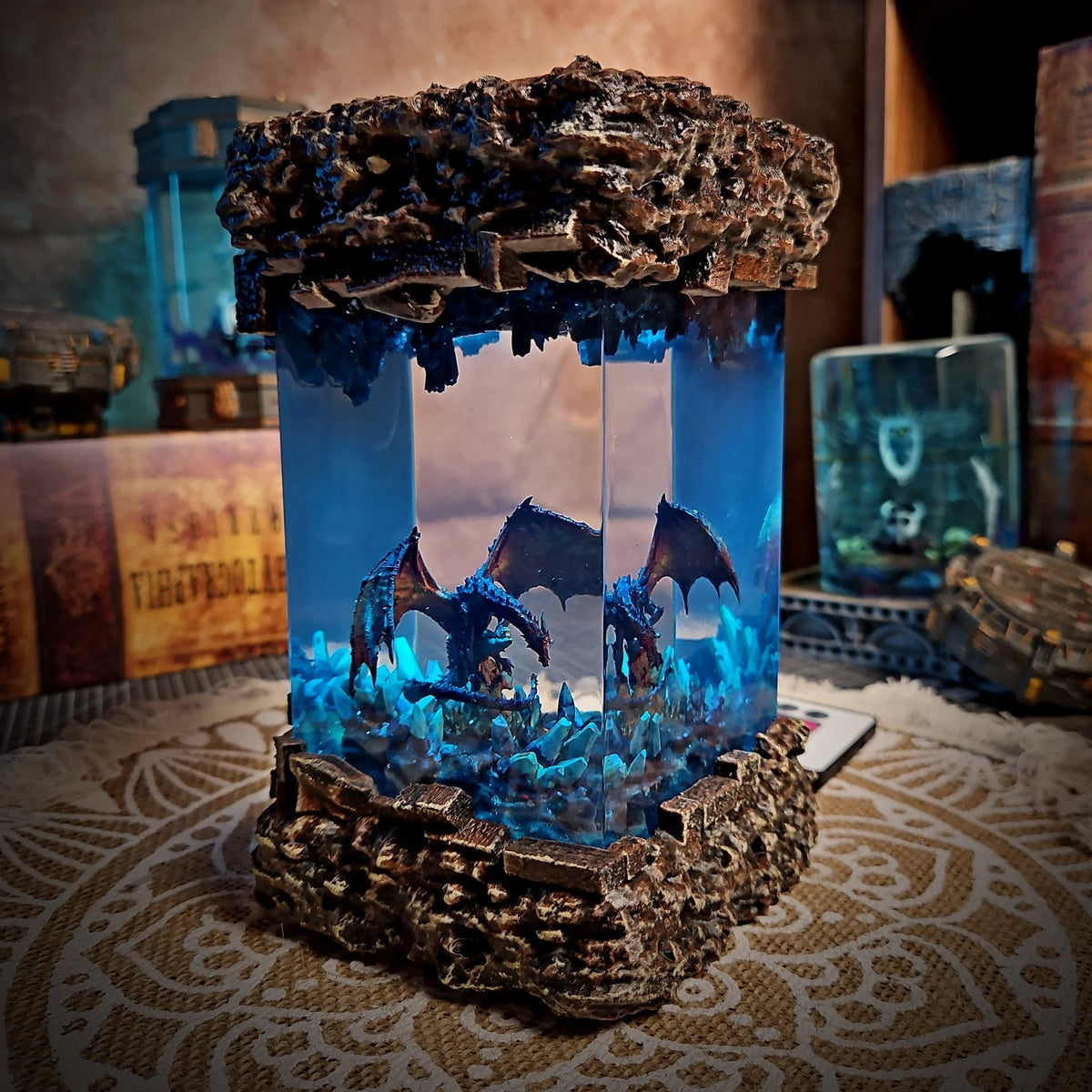 Winged dragon on crystals inside a blue-lit resin column